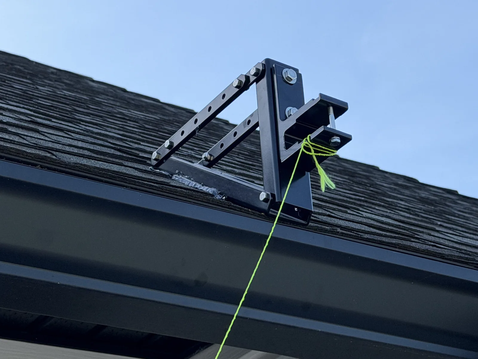 Close-up of the fabricated roof bracket securing the motorized awning in Fruit Cove, FL