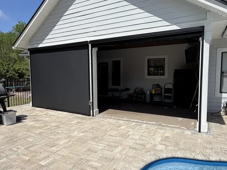 Motorized retractable solar screen using dense Textilene Nano 99 fabric on a Pecan Park, Jacksonville patio