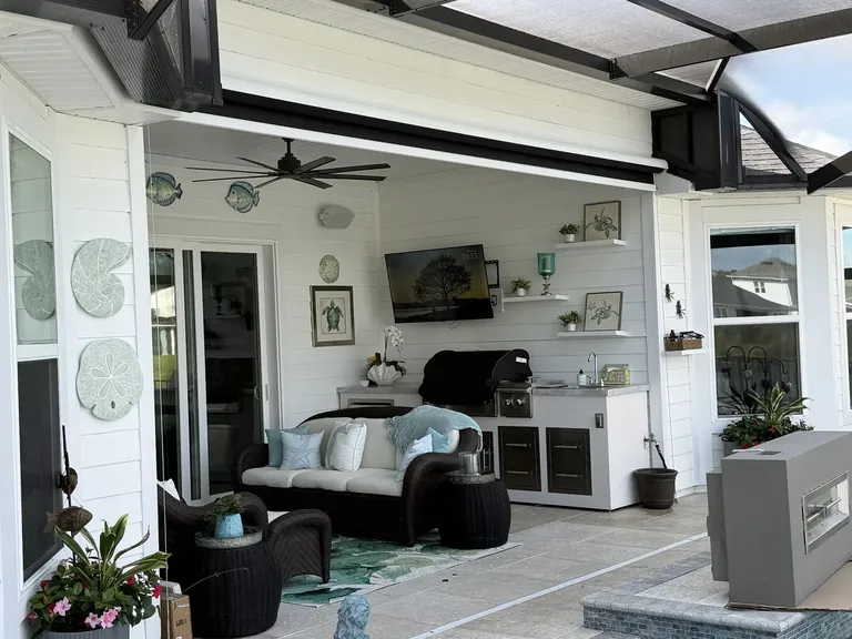 OpenRoller cable-guided solar screen with Phifer SunTex 95 fabric on a covered patio in SilverLeaf, St. Johns County, Florida