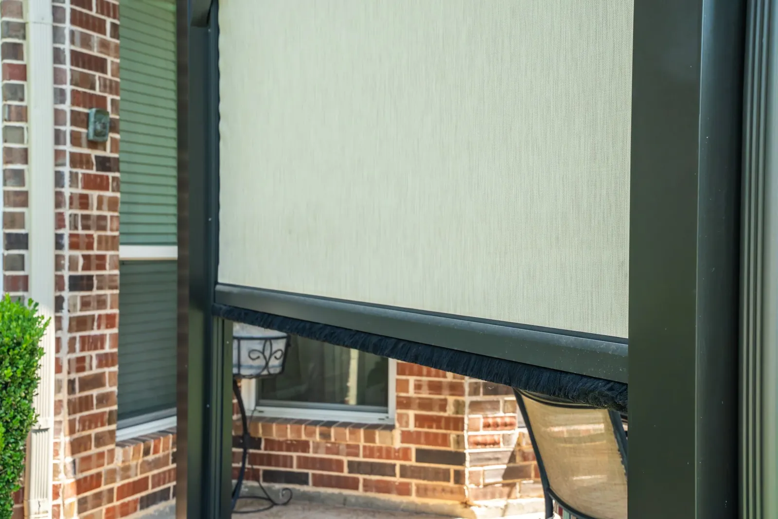 Solar screen shading a covered patio enclosure