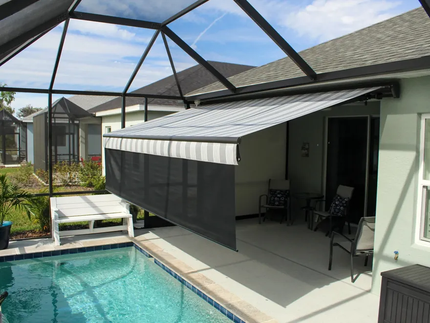 Retractable awning extended over a screened lanai and pool cage on a Northeast Florida home