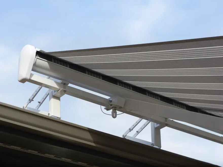 White-housing motorized awning roof-mounted above a second-story deck