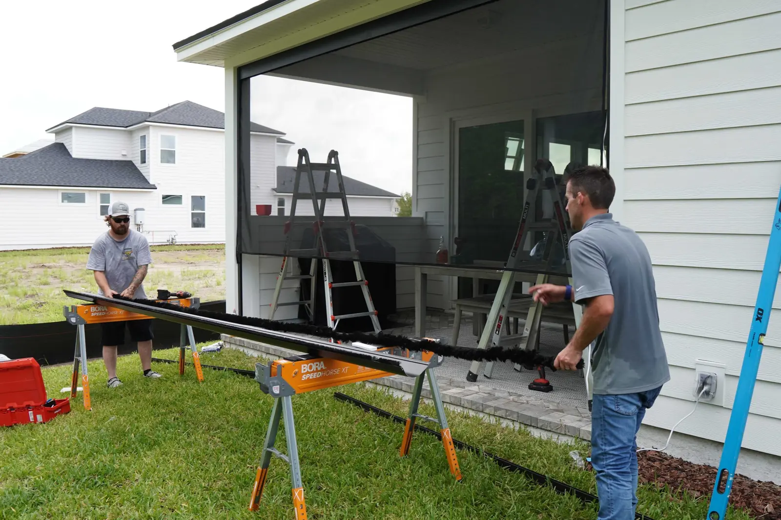 Cheetah Screens technicians installing a retractable screen system