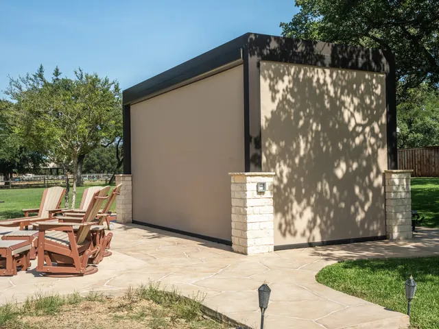 Motorized screens enclosing a poolside pergola, exterior view