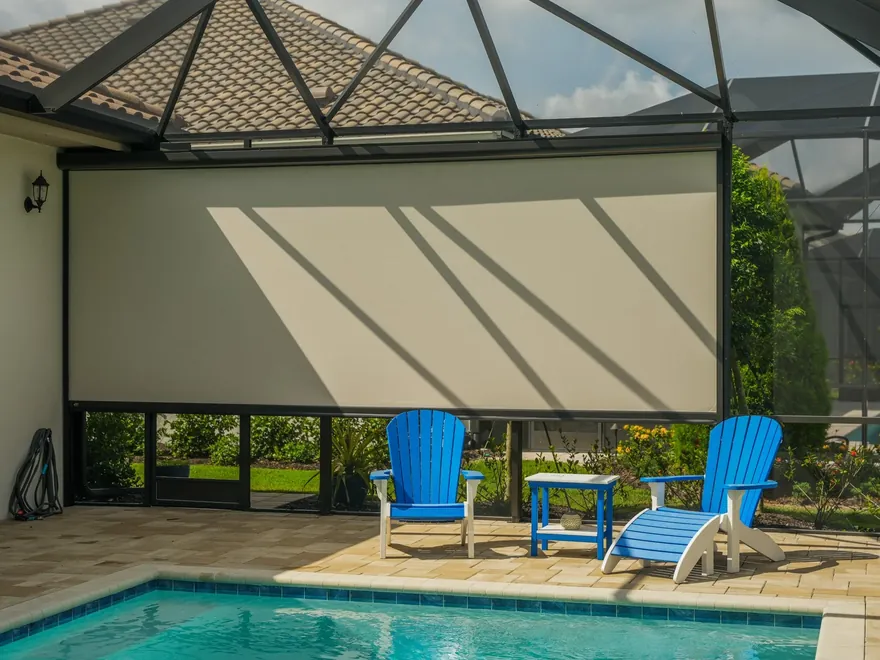 Interior view of a screened pool cage with motorized retractable screens lowered