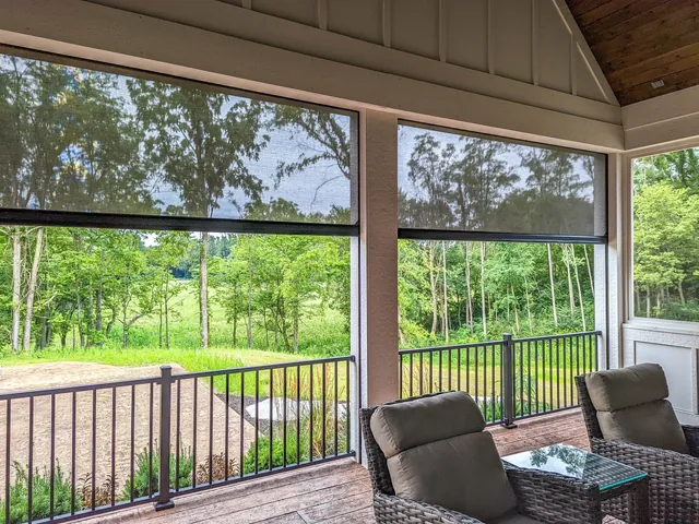 Recessed motorized patio screen on a residential porch, close-up view