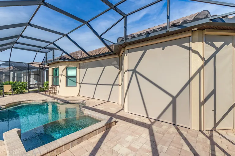 Exterior view of multiple beige privacy screens installed on a Florida home for shade and privacy