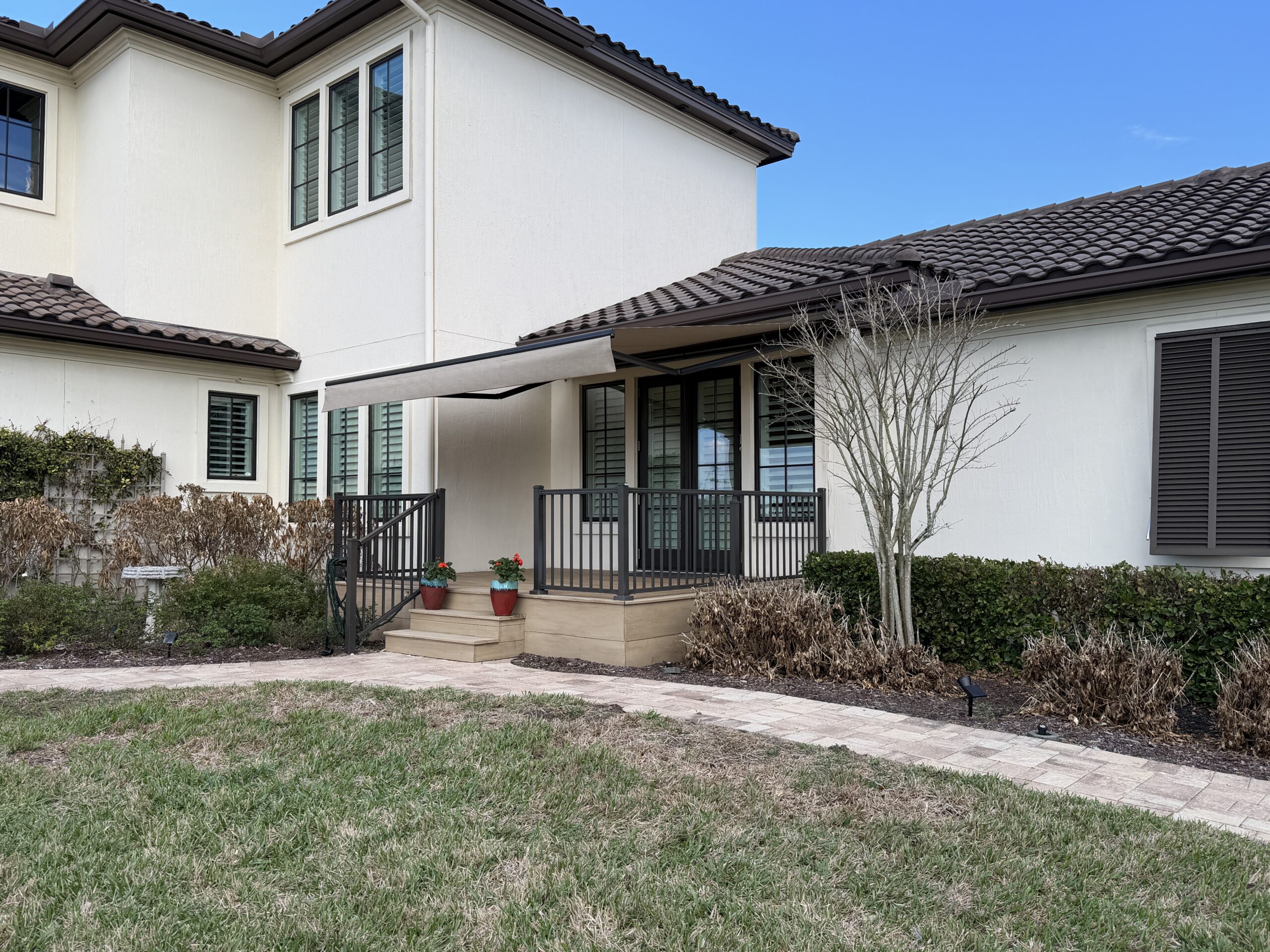 14 by 12 foot motorized awning paired with an OpenRoller cable solar screen in Marsh Landing, Ponte Vedra Beach, FL