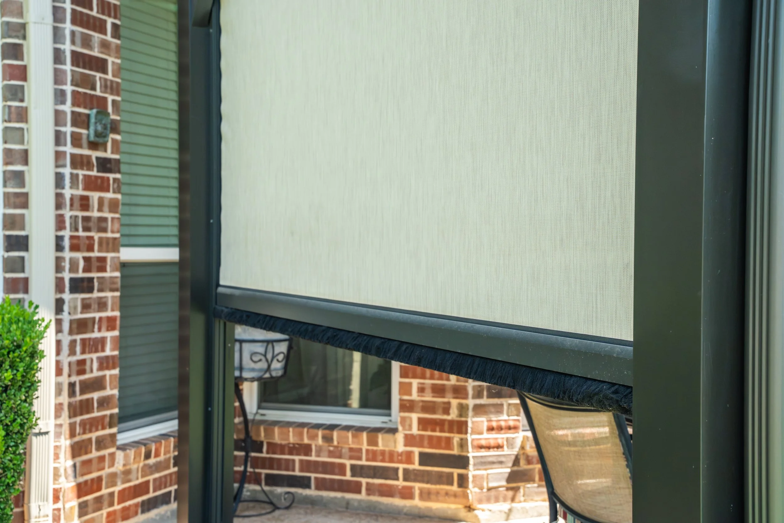 Solar screen shading a covered patio enclosure