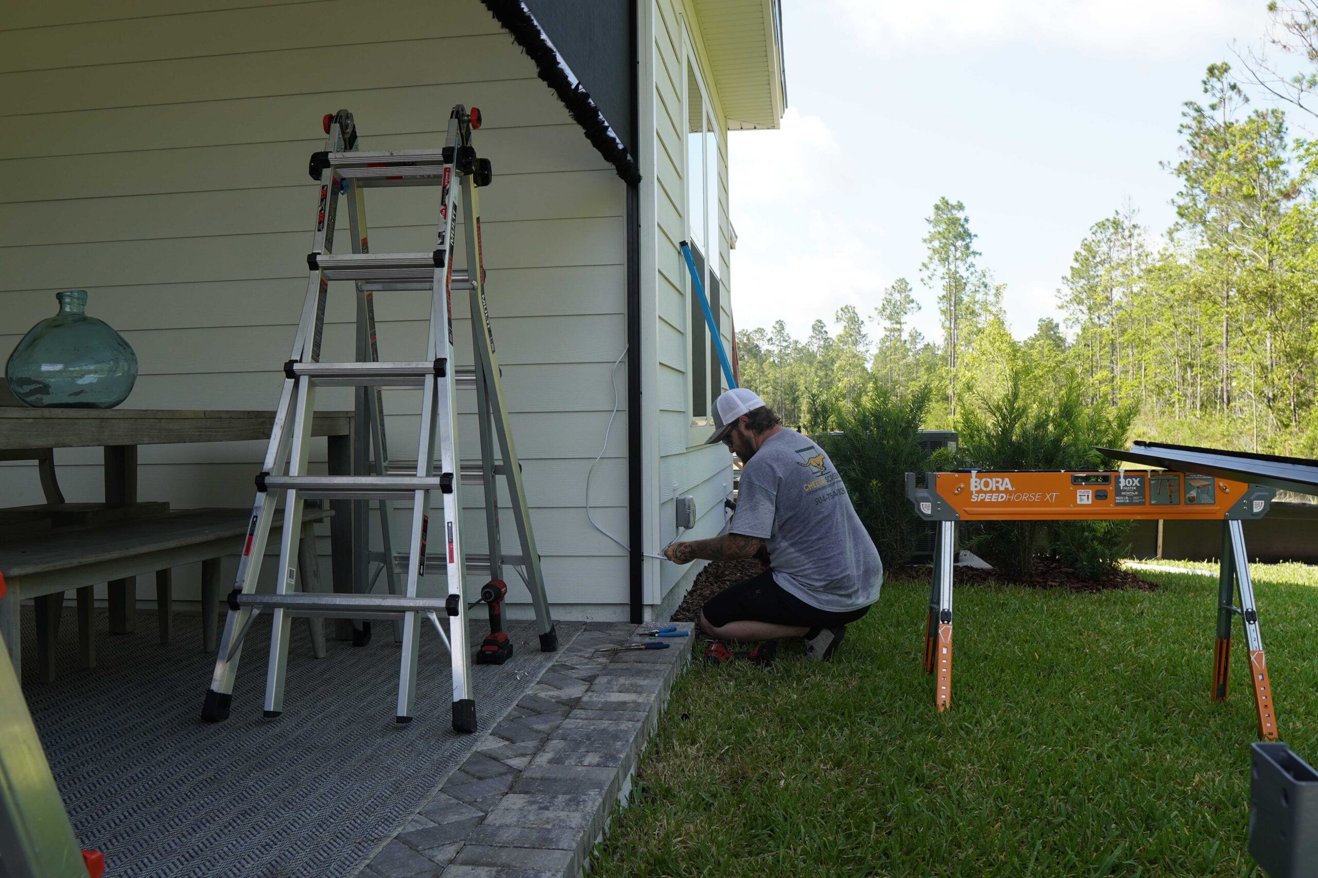 Cheetah Screens technician securing the base of a retractable screen system